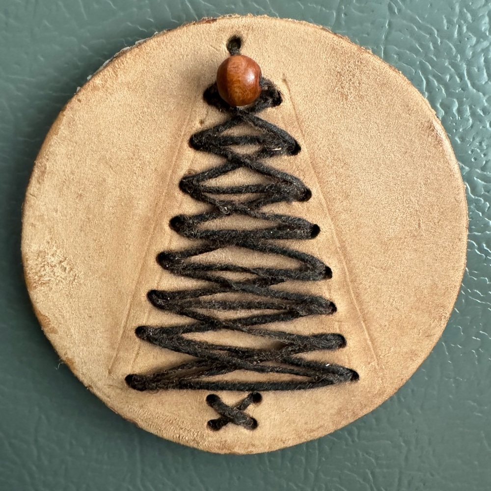Handmade hand sewn Christmas tree magnet with leather and wood backing.
